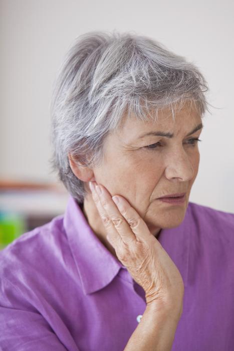 older woman in jaw pain | tmj treatment mt pleasant sc