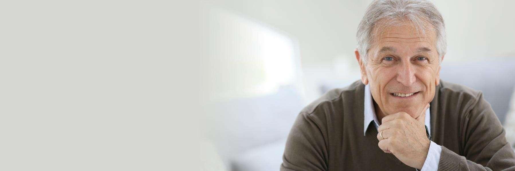Man with dental implants smiling at dentist in Mt Pleasant SC