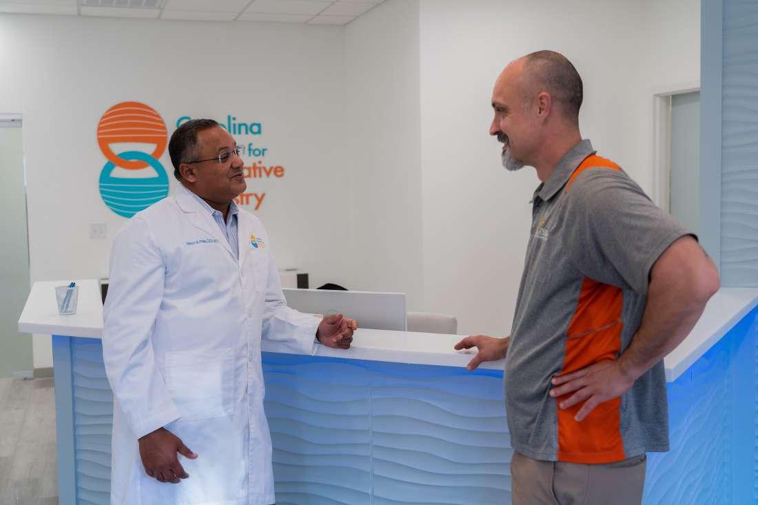 Dr. Mayur Patel prosthodontist speaking with dental patient in Mt Pleasant, SC